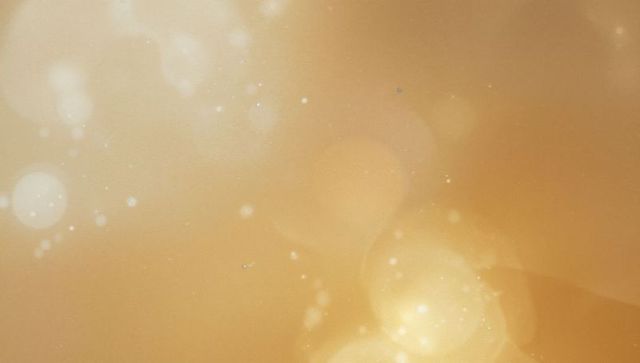 Luxurious shimmering golden bokeh with glowing orbs