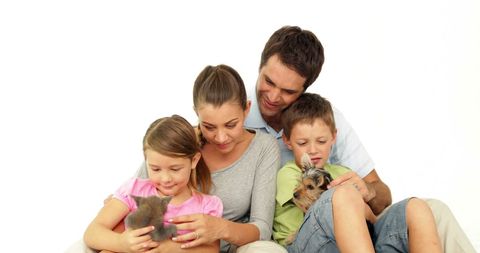 Happy Family With Kitten and Puppy at Home