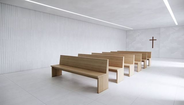 Minimalist chapel interior featuring light oak pews, clean lines, wall cross and soft light