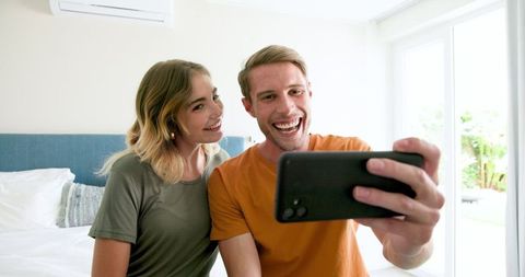 Happy Couple Taking Selfie in Modern Living Room