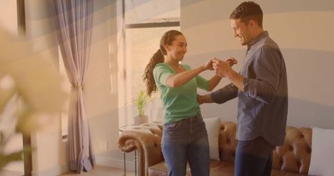 Joyful Couple Sharing Dance in Cozy Living Room Embracing Memories