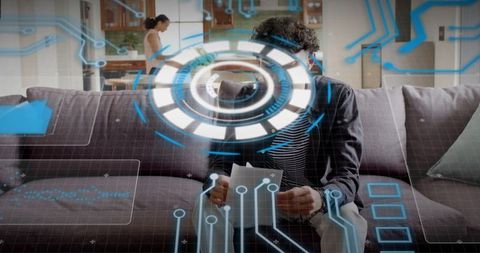 Man Reviewing Documents on Couch with Futuristic Augmented Reality HUD Overlay