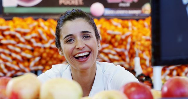 Smiling Woman Inside Fruit Market Surrounded by Apples and Oranges - Download Free Stock Images Pikwizard.com
