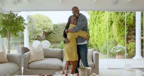 Joyful Couple Celebrating Affection in Sunlit Living Room