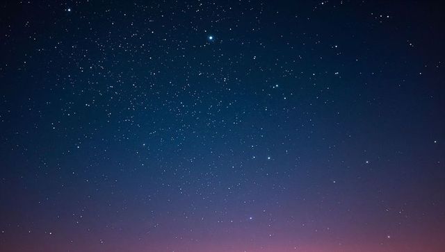 Vast Starry Night Sky Showing Twinkling Stars and Indigo-Pink Horizon Glow