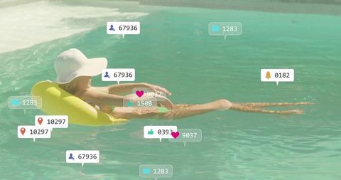 Woman floating on yellow pool float wearing wide-brim hat with social media notifications