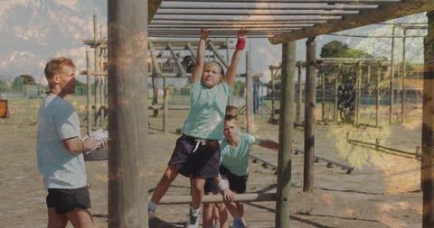 Young Girl Navigating Monkey Bars in Team-Building Course