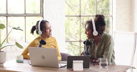 Two Female Podcasters Recording in Bright Studio