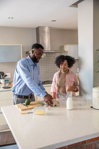 Preparing Meal in Modern Kitchen with Focus on Collaboration
