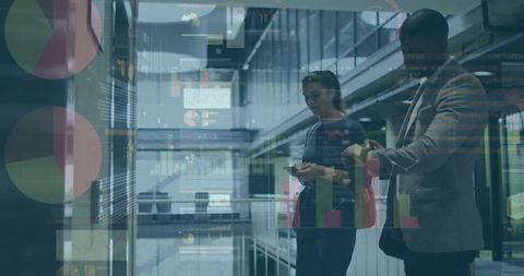 Consulting professionals reviewing analytics with dashboard overlays in sleek atrium