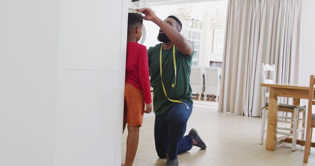 Father Measuring Son's Height in Modern Living Room - Download Free Stock Images Pikwizard.com