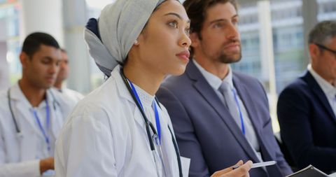 Diverse medical professionals attending business seminar
