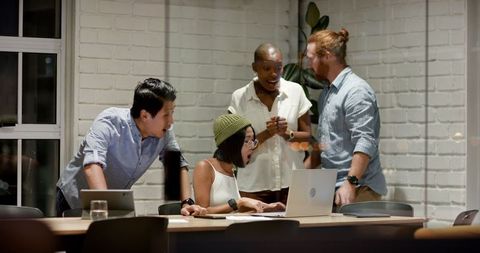 Diverse Team Collaborating in Late-Night Office Meeting