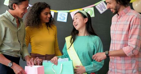Multiracial colleagues celebrating office baby shower ceremony