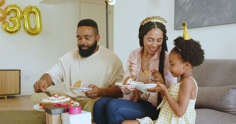 Family Birthday Celebration with Cake and Party Hats