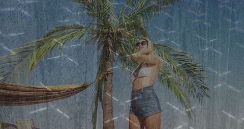 Woman Enjoying Sunny Beach Day Against Palm Tree Background