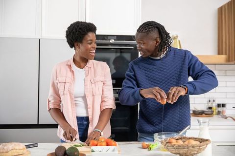 Cheerful Couple Cooking Together in Modern Home Kitchen
