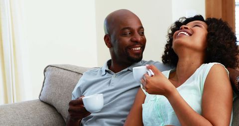 Happy Couple Relaxing with Coffee on Comfortable Couch - Download Free Stock Images Pikwizard.com