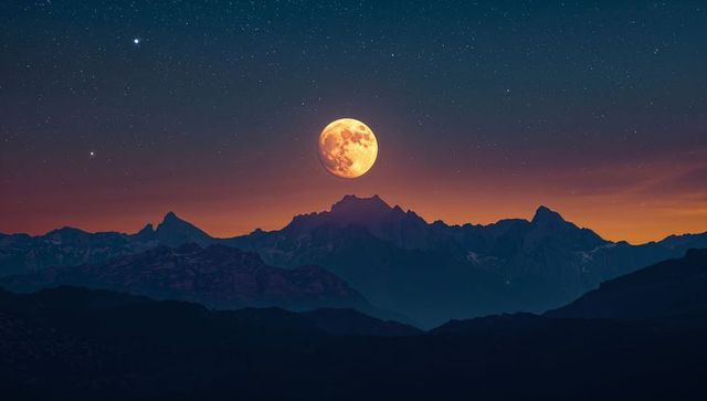 Full moon illuminating mountain ridges at twilight