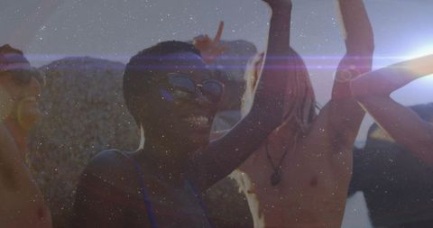 Joyful Friends Dancing on Rooftop at Sunset Party