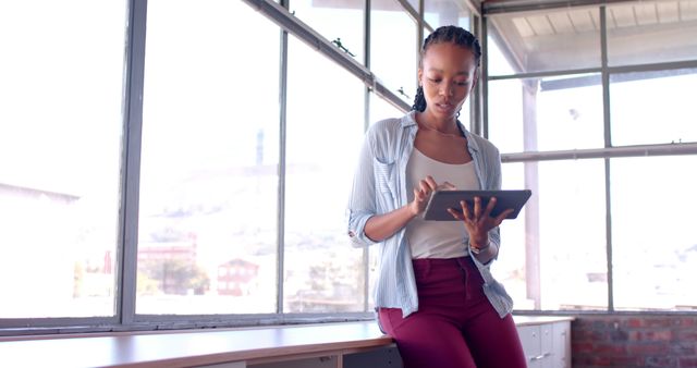 Young Professional Woman Using Tablet by Office Window - Download Free Stock Images Pikwizard.com