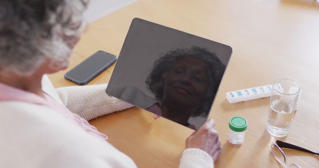 Senior Woman Reflecting on Tablet with Medication Dispenser - Download Free Stock Images Pikwizard.com