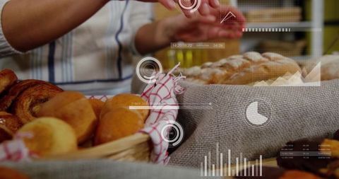 Baker arranging rustic bread and rolls at market stall with futuristic data hud overlay