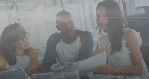 Diverse team collaborating on financial project in bright office