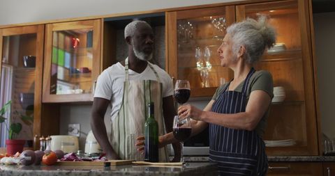 Senior Couple Enjoying Wine Together in Kitchen - Download Free Stock Images Pikwizard.com
