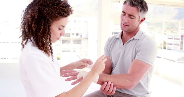 Nurse Wrapping Bandage on Male Patient's Hand in Hospital - Download Free Stock Images Pikwizard.com