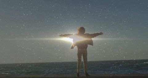 Ethereal Beach Moment with Sun Flare and Ocean Horizon