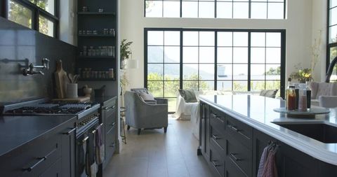 Modern Farmhouse Kitchen Island Featuring White Countertop, Integrated Sink and Grid Windows