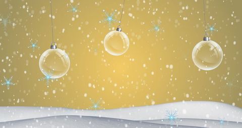 Hanging Christmas Baubles Amidst Falling Snow and Golden Backdrop