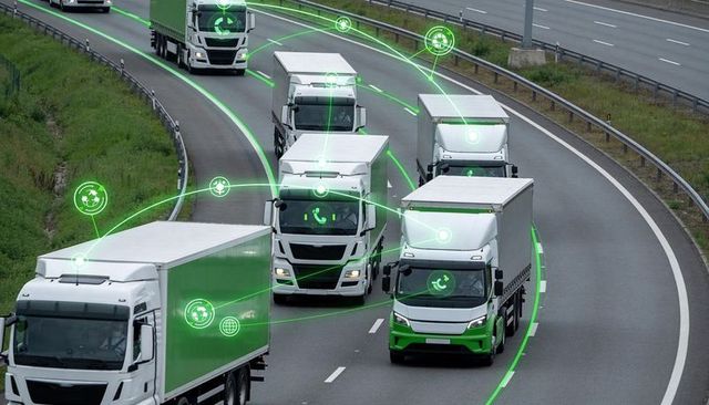 Connected electric truck convoy navigating curved highway with digital fleet network