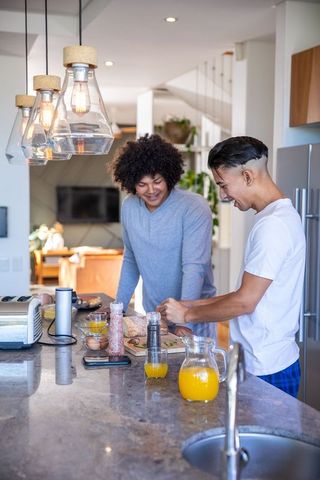 Roommates preparing breakfast in modern kitchen setting