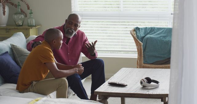 Father and Son Having Serious Conversation in Living Room - Download Free Stock Images Pikwizard.com