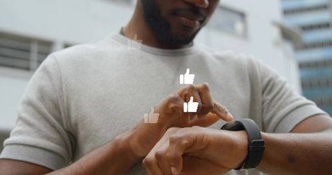 Black man tapping smartwatch in urban plaza with thumbs-up overlays, wearable interaction