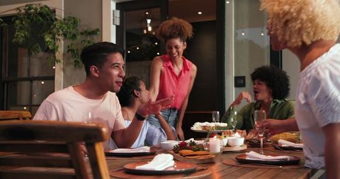 Diverse Friends Celebrating at Outdoor Dinner Party