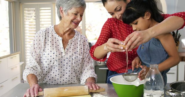 Three generations baking together in a bright kitchen, showing teamwork and family bonding. Grandmother rolling dough, mother helping daughter sift flour into mixing bowl. The image represents family values, joy, and learning cooking skills together. Perfect for advertisements focusing on family, cooking blogs, and educational content about baking.