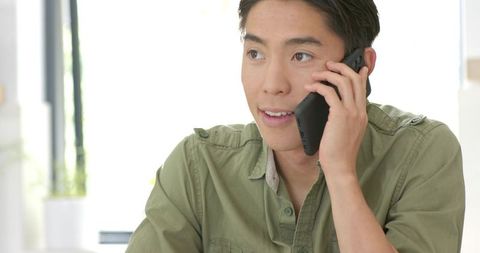 Young Man Enjoys Conversation in Relaxed Minimalist Home Setting