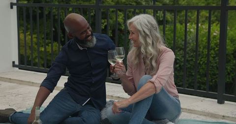 Romantic Mature Couple Toasting Wine Outdoors on Scenic Patio