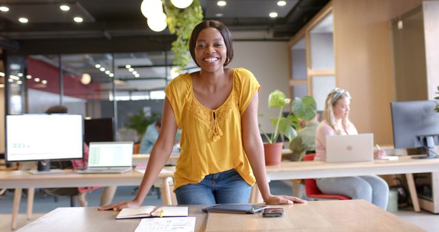 Confident Young Professional Woman Smiling in Modern Office Workspace - Download Free Stock Images Pikwizard.com