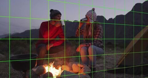 Couple Enjoying Campfire Evening in Mountain Wilderness
