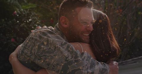 Service Member Embraces Woman in Romantic Outdoor Setting