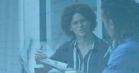 Coworkers discussing sales revenue in office with transparent fiscal data