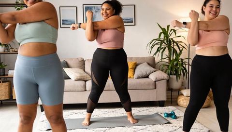 Plus-Size Women Stretching Together During Home Group Workout on Yoga Mat