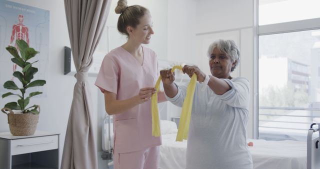 Physical Therapist Assisting Senior Woman with Exercise Bands in Clinic - Download Free Stock Images Pikwizard.com