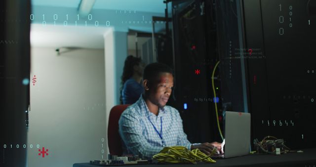 IT Technician Working on Laptop in Server Room with Data Overlay - Download Free Stock Photos Pikwizard.com