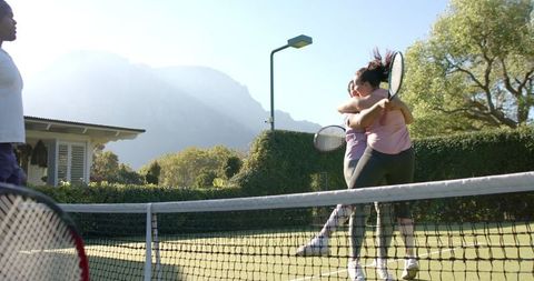 Diverse Friends Celebrating Victory on Outdoor Tennis Court