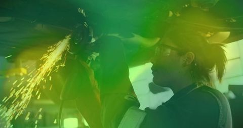 Woman Using Angle Grinder for Automotive Repairs